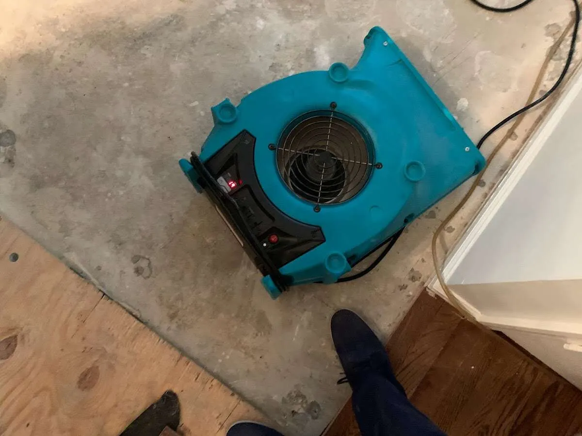 Air mover drying subfloor during Commercial Water Damage Restoration in Birmingham